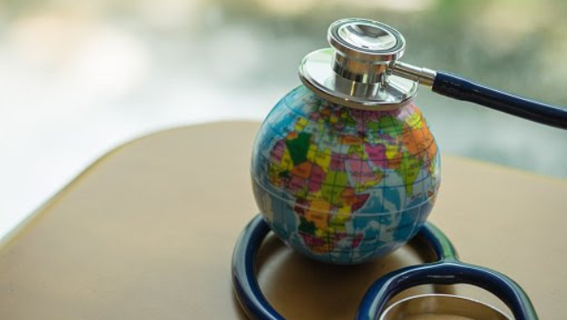 Stethoscope on top of small globe