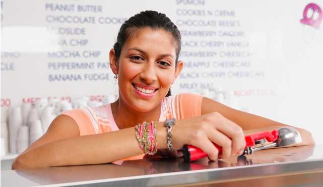 Girl behind the counter working at an ice cream shop