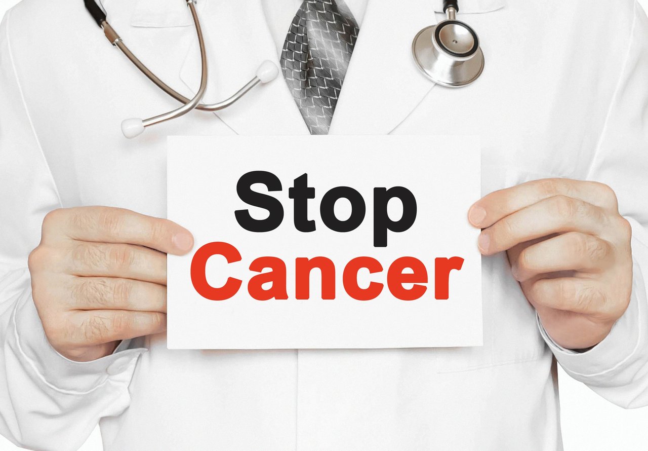Doctor holding sign that says Stop Cancer