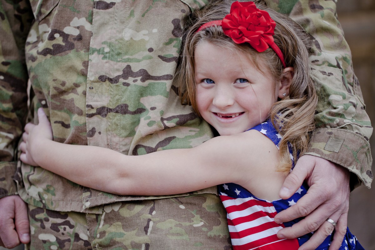 Military daughter hugging her parent